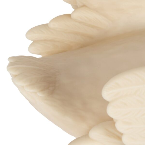 Studio lighting, close up view of a decorative swan-shaped lamp's feathers.