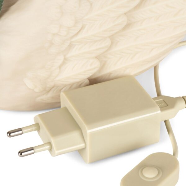Studio lighting, close up view of a decorative swan-shaped lamp's wall plug.