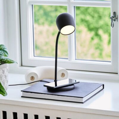 KREAFUNK Ellie Lamp w Speaker and Wireless Charger, Black 2 by a window.
