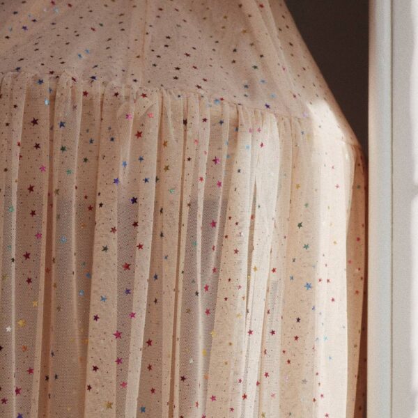 Multi sparkle kid's bed canopy from Konges Slojd is crafted from a soft and lightweight fabric creates a whimsical decor in kid's room.